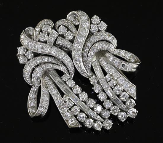 A mid 20th century white gold and diamond double clip scroll brooch, 50mm.